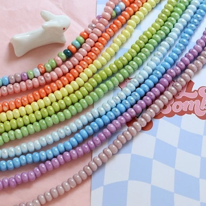 Macro shot of macaron color flat round ceramic beads with pearlescent finish for DIY jewelry