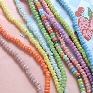 Macro shot of macaron color ceramic beads in pink, yellow, blue for DIY jewelry making