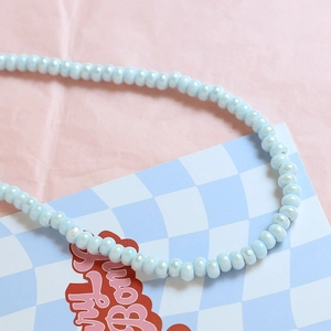 Macro shot of light blue pearlescent ceramic beads for DIY jewelry making material
