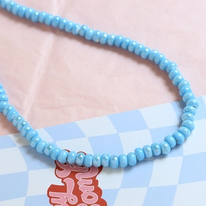 Close-up of sky blue macaron ceramic beads with pearlescent finish for DIY jewelry