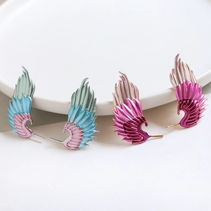 Two pairs of colorful enamel feather wing earrings in blue and purple gradient finishes