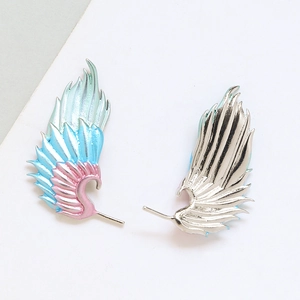 Detail of colorful gradient enamel feather wing earrings with gold plating and DIY pin parts