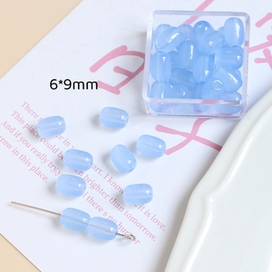 Vue détaillée de perles en verre bleu clair 6x9mm pour création de bijoux artisanaux
