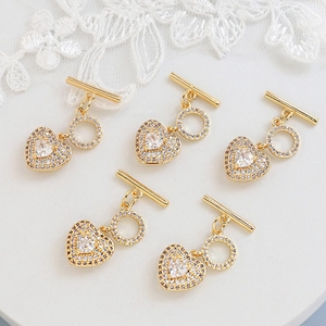 Five-piece gold-plated heart OT toggles with micro-pave cubic zirconia on lace background