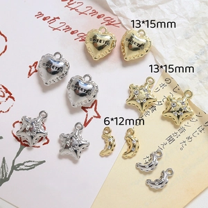 Detailed view of gold and silver heart star and moon pendants for DIY jewelry making