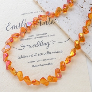 Close-up of orange iridescent irregular crystal glass beads for DIY jewelry making
