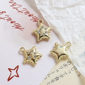 Macro detail of gold plated star pendants with sparkling zircons for jewelry making