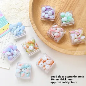 Close-up of colorful 10mm flat glass beads for DIY jewelry making in clear storage boxes