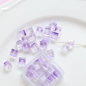 Macro detail of square purple glass bubble beads for DIY handmade jewelry crafts