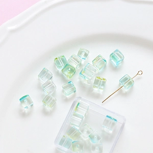 Macro detail of cube glass beads with aurora gradient for DIY jewelry making