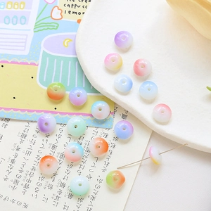 Flat lay of colorful gradient flat round glass beads for DIY jewelry making and crafts