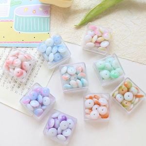 Flat round glass beads in pastel gradient colors for DIY jewelry making in clear boxes