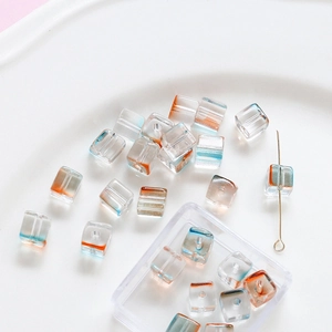 Macro detail of cube glass beads with blue and orange gradient for DIY jewelry making