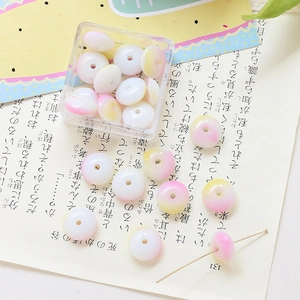 Close-up of pink and yellow gradient flat round glass beads for DIY jewelry making