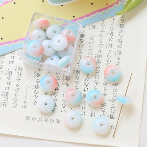 Detail of blue and pink gradient glass flat round beads for DIY handmade jewelry crafts