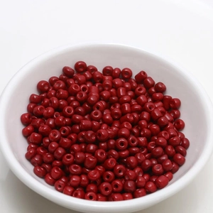 Detailed view of 4mm dark red porcelain beads for DIY jewelry making in a white bowl