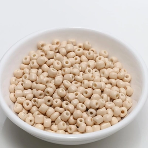 Detailed close-up of 4mm off-white round ceramic beads for DIY jewelry making in a white bowl