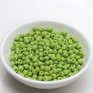 Light green 4mm ceramic seed beads for DIY jewelry making in a white ceramic bowl