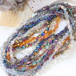 Close-up of iridescent multifaceted square glass beads for DIY jewelry making crafts