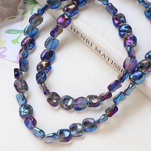 Detailed view of irregular square beads with vibrant AB rainbow metallic coating