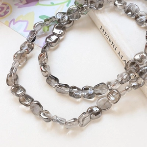 Close-up of grey transparent faceted glass beads for DIY jewelry making and crafts