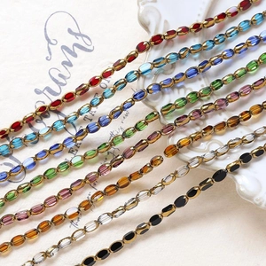 Macro view of multi-colored faceted oval crystal glass beads with gold connectors