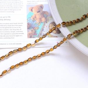 Macro detail of amber crystal beads on a ceramic plate for DIY jewelry making