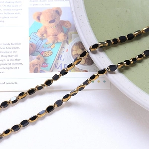 Macro view of vintage style black oval beads with gold edges for DIY jewelry making