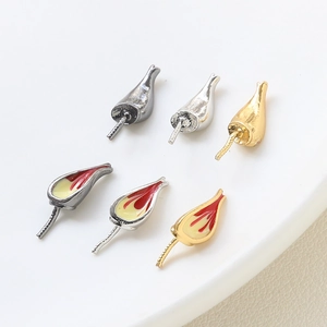Detailed view of DIY metal flower charms in gold, silver, and black for jewelry making