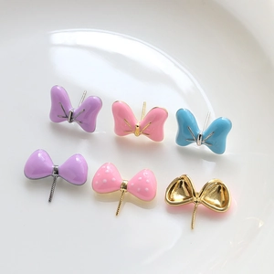 DIY bow tie jewelry accessories in colorful enamel finishes and white polka dot patterns