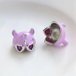 Detail of purple devil charms with heart-shaped crystal eyes for DIY jewelry making