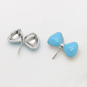 Detailed front and back view of light blue enamel bow charm for DIY jewelry making