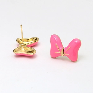 Detail of bright pink enamel butterfly bow stud earring with gold-plated metal finish