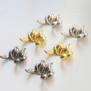 Polished nine-tailed fox tail metal pendants in gold, silver, and black finishes