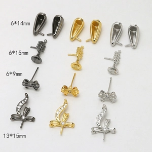 Detail of assorted copper plated bow and cone charms for DIY baroque jewelry making