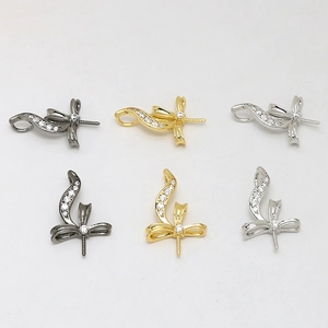 Bow-shaped brass pendant settings with zircon inlay in gold, silver, and black tones