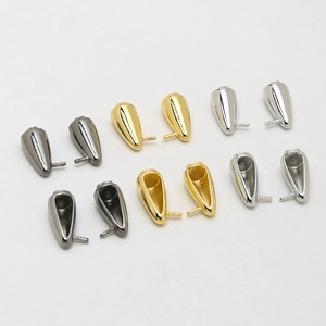 Detailed view of cone-shaped jewelry pendant caps in gold, silver, and black finishes
