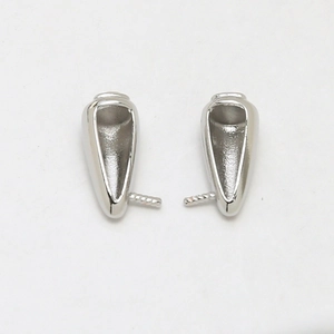 Detailed view of silver cone-shaped jewelry connectors for pearl or gemstone settings