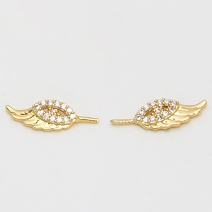 Detailed view of gold-plated bat wing accessories with pavé white cubic zirconia inlay