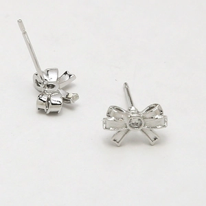 Detailed silver bow stud earrings with center zircon stone and secure needle back
