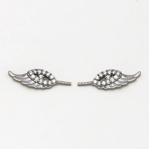 Detail of dark gunmetal wing-shaped accessories with embedded sparkling white cubic zirconia