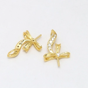 Detail view of gold-plated ribbon bow jewelry accessories with sparkling zircon stones