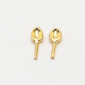 Detailed view of creative gold-plated spoon-shaped earrings on a white background