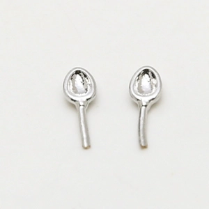 Detail view of silver spoon shaped ear studs made of polished plated copper metal