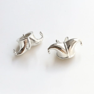 Close-up of silver-plated joker hat pendant charms for DIY jewelry making and crafting