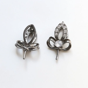 Detail of black plated iris-shaped jewelry connectors with sparkling white zircons
