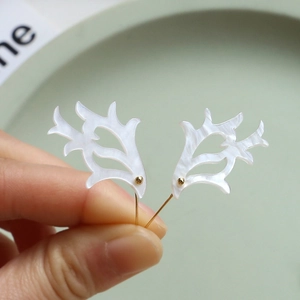 Handcrafted white acetate antler ear studs with pearl texture and gold bead accents