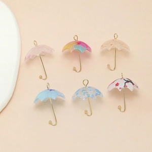 Detailed view of colorful floral resin umbrella charms with golden metal handles