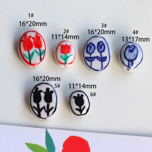 Macro shot of hand-painted ceramic tulip beads in various sizes for DIY jewelry making