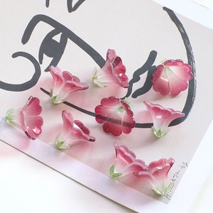 Macro detail of translucent gradient pink floral charms for DIY jewelry and hair accessories